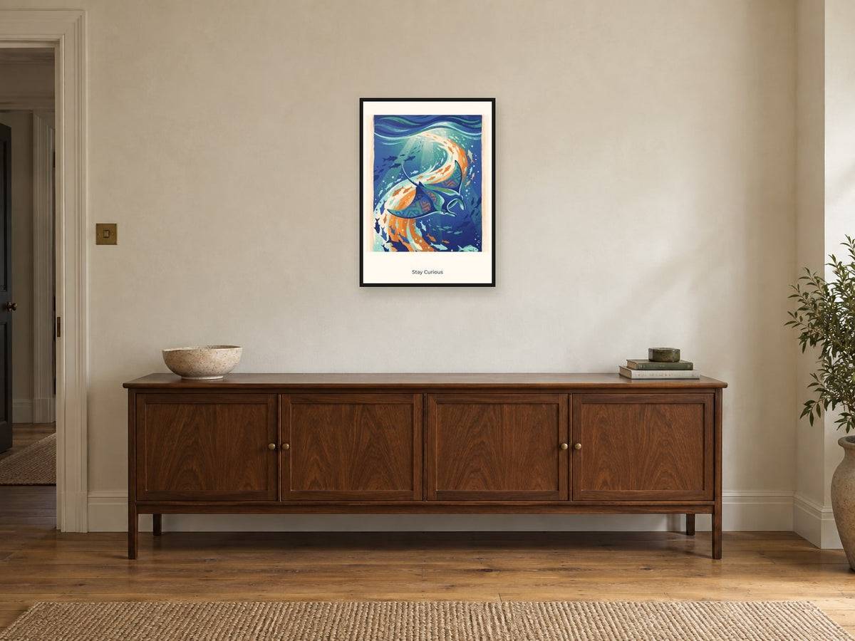 Stay Curious — Deep Blue Discovery Children’s Art Print at A2, in a black frame, above a sideboard