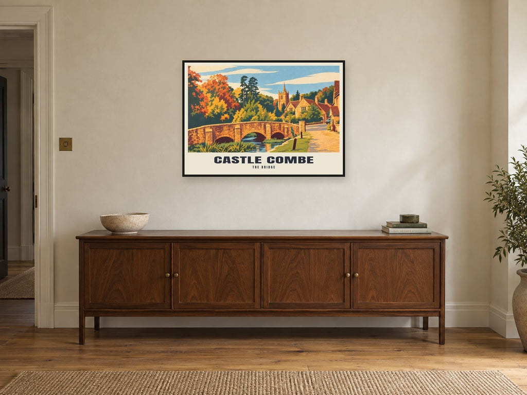 The Bridge, Castle Combe Poster at A1, in a black frame, above a sideboard