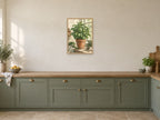 Basil on the Ledge — A2 artwork shown in a room with a natural wood frame; select a framed finish to include a frame