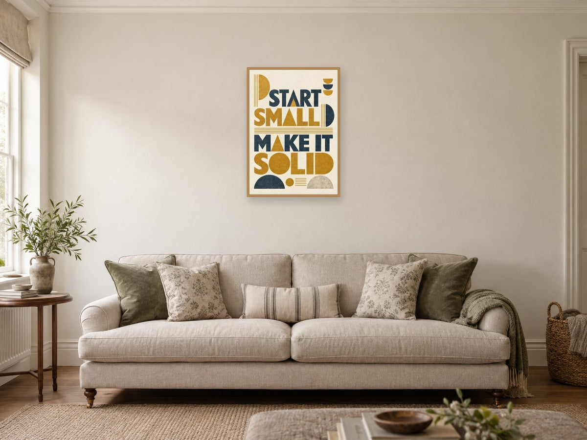 Start Small Make It Solid — A2 artwork shown in a room with a natural wood frame; select a framed finish to include a frame