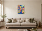 Colour Belongs Here — A2 artwork shown in a room with a natural wood frame; select a framed finish to include a frame