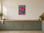 The Pomegranate Plate — A2 artwork shown in a room with a natural wood frame; select a framed finish to include a frame
