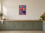 Peaches in the Pink Bowl — A2 artwork shown in a room with a natural wood frame; select a framed finish to include a frame