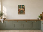 The House Table — A2 artwork shown in a room with a natural wood frame; select a framed finish to include a frame