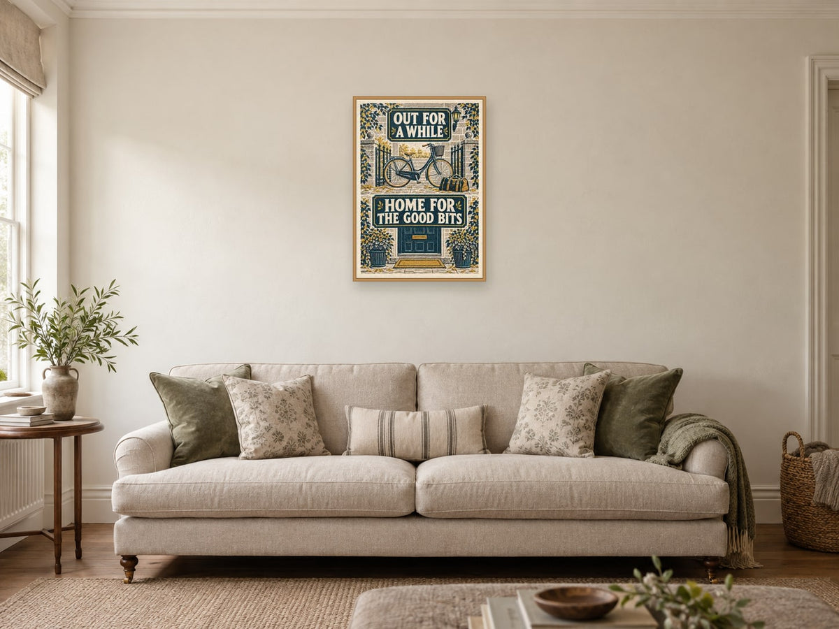 Out for a While Home for the Good Bits — A2 artwork shown in a room with a natural wood frame; select a framed finish to include a frame