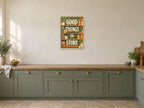 Good Things In Store — A2 artwork shown in a room with a natural wood frame; select a framed finish to include a frame