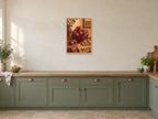 Plums and walnuts on a richly woven cloth — A2 artwork shown in a room with a natural wood frame; select a framed finish to include a frame