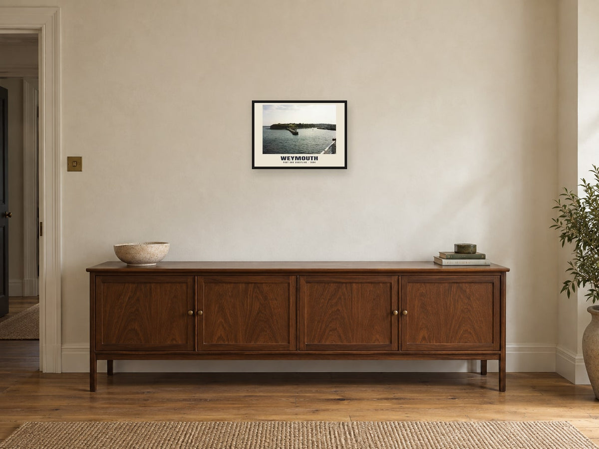 Port and coastline, Weymouth, 1994 Heritage Print at A3, in a black frame, above a sideboard